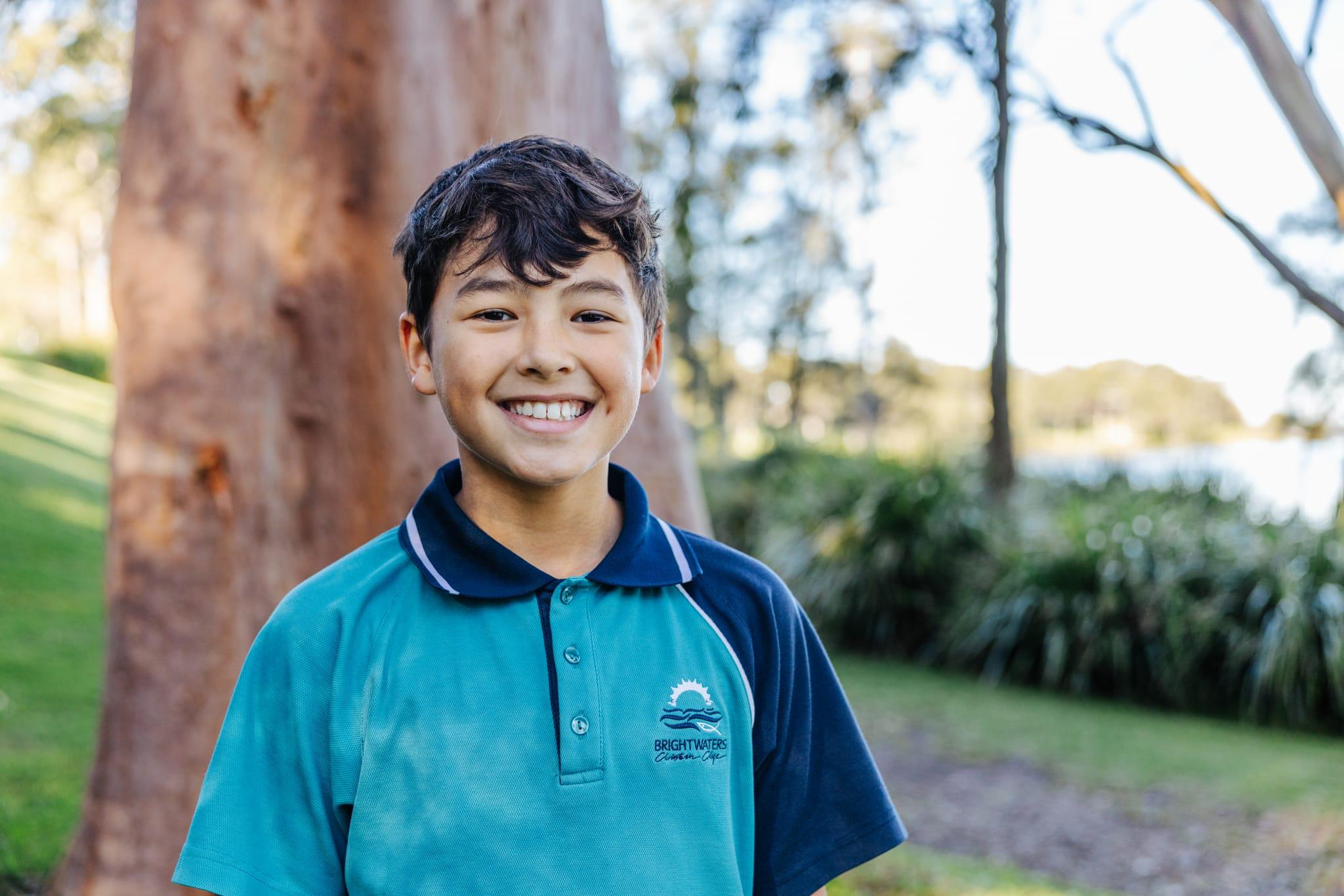 Smiling student enjoying Christ-centred education outdoors at Brightwaters Christian College