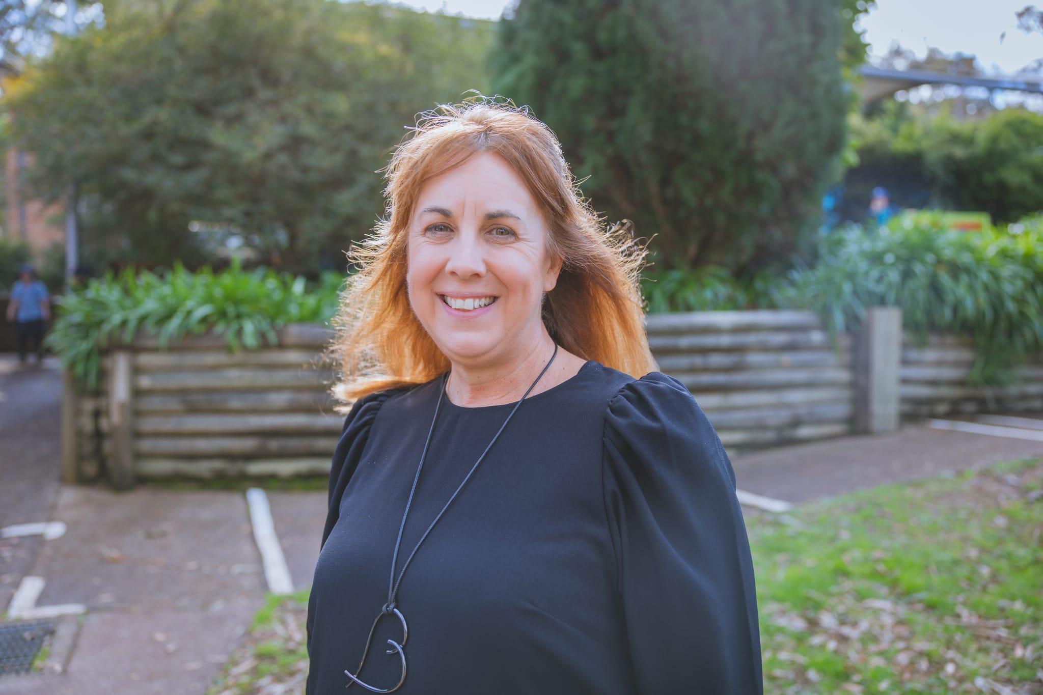 Principal Tania Anway smiling outdoors on our Lake Macquarie campus