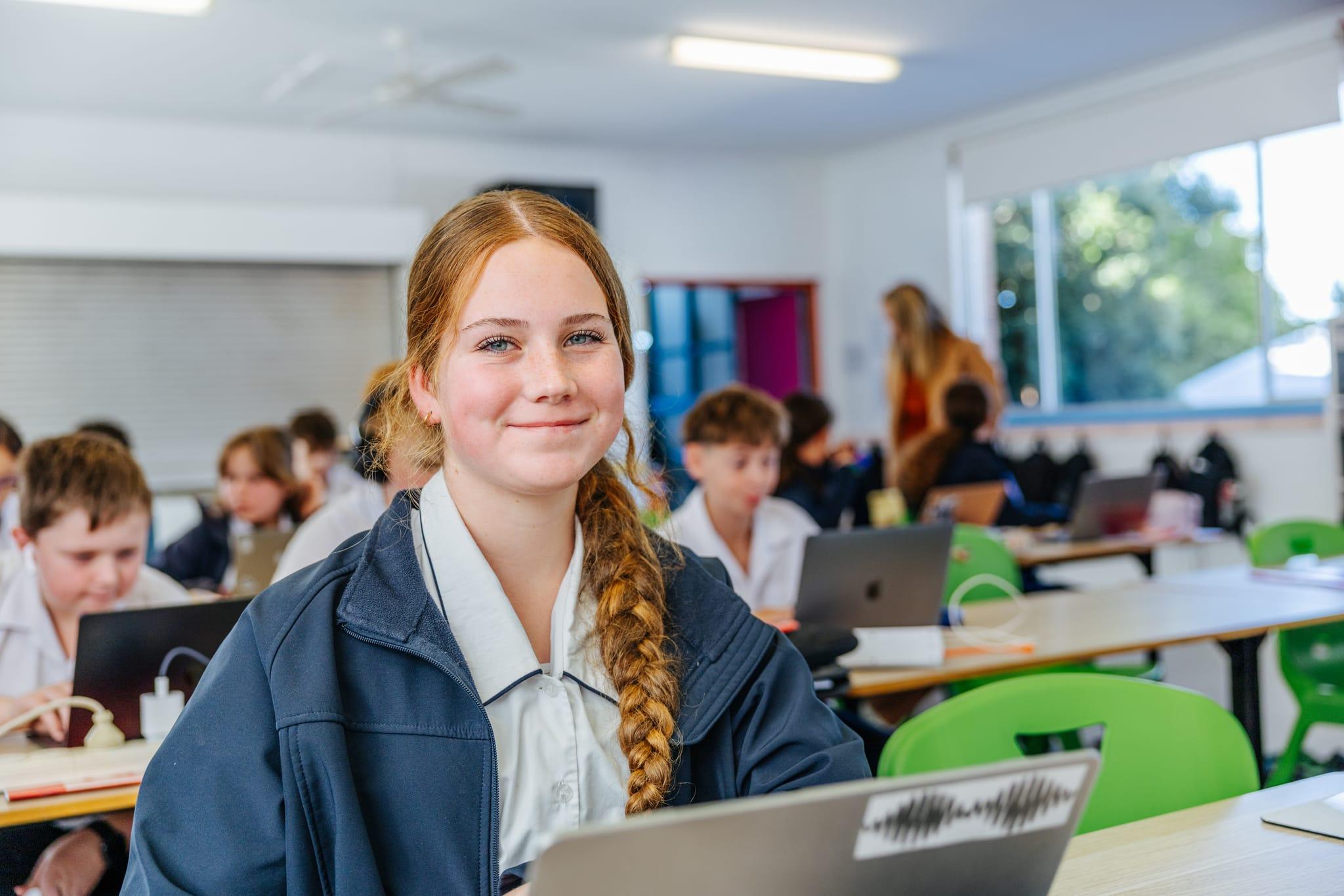 Secondary student smiling during a classroom lesson at Brightwaters Christian College near Morisset NSW