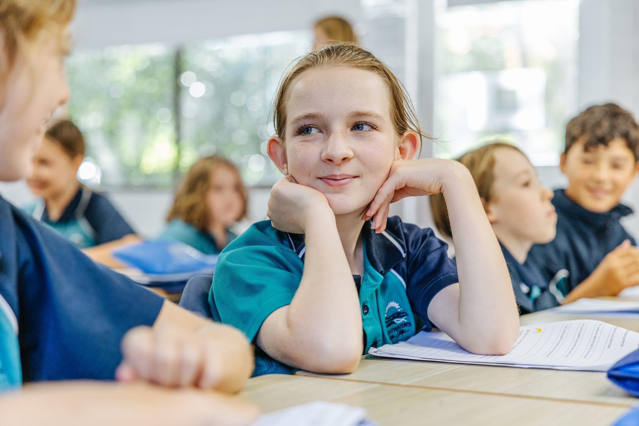 Student smiling and listening attentively during a classroom lesson at Brightwaters Christian College near Morisset NSW.
