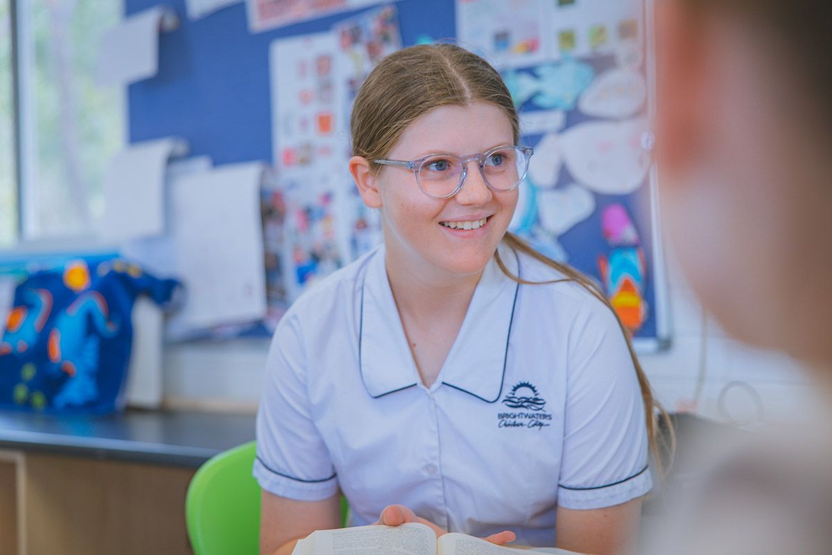 Studious male high school student sitting in classroom