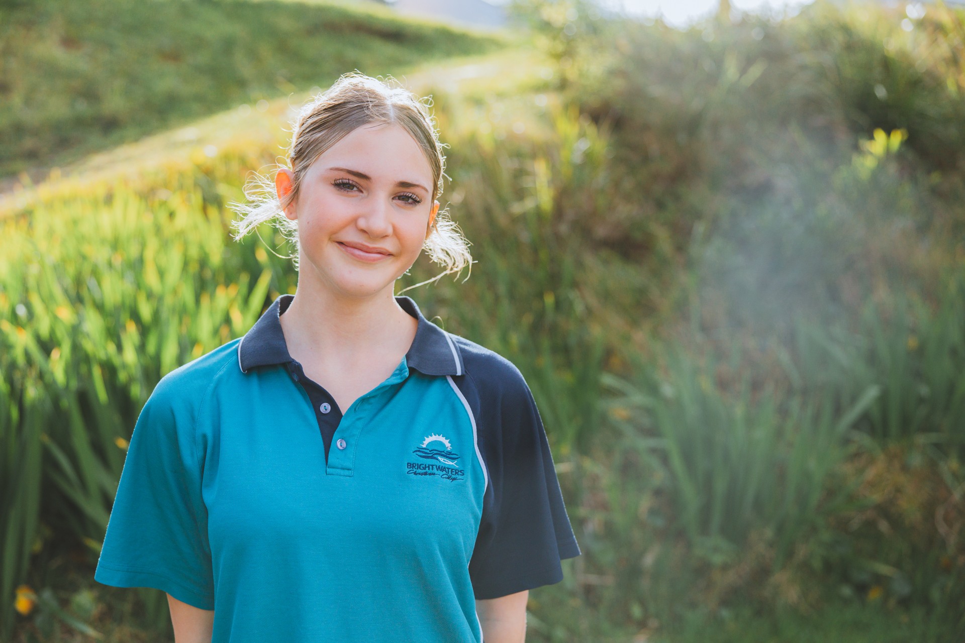 Lake Macquarie high school girl smiling in Brightwaters Christian College polo shirt