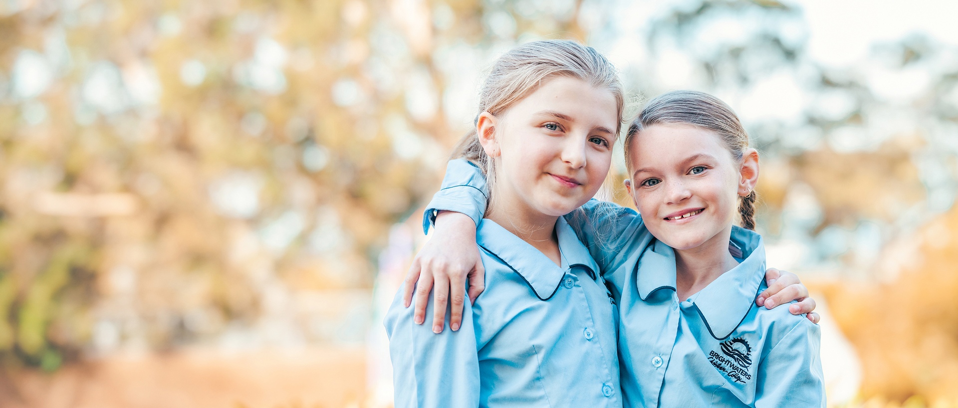 Two happy Brightwaters Christian College students who are hugging