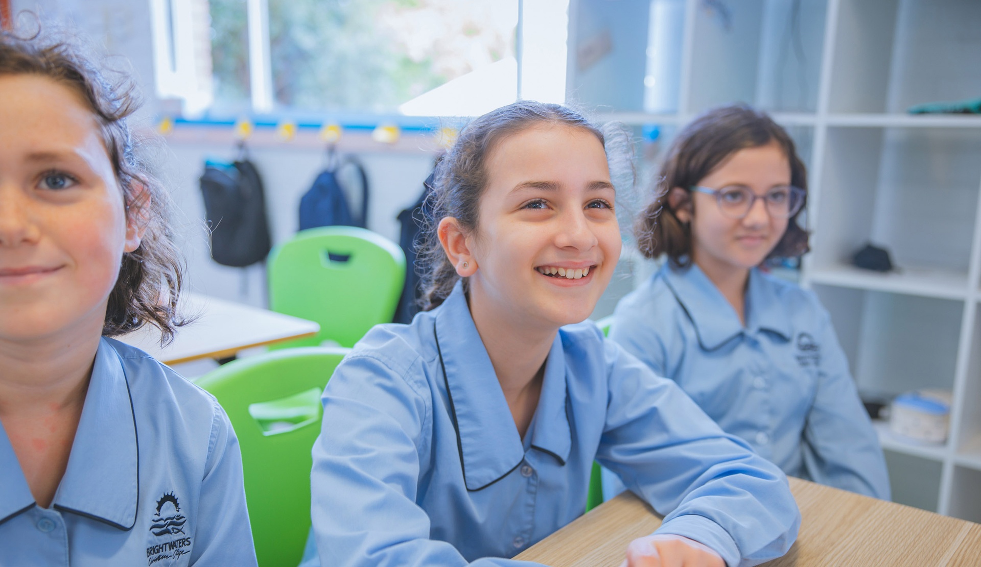 smiling female student in light-blue uniform