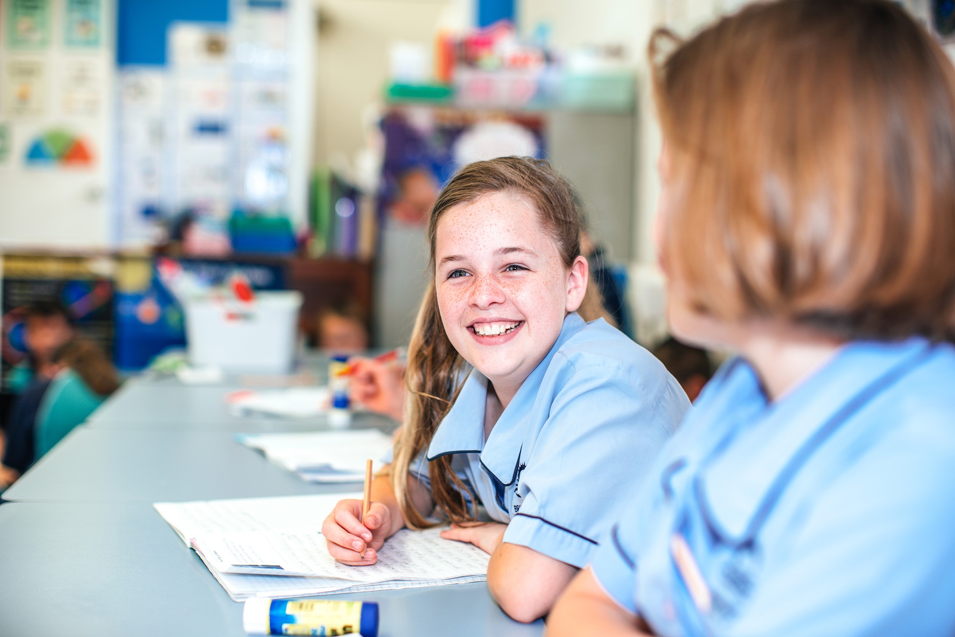 smiling female student in light-blue uniform